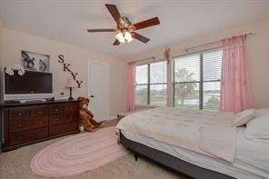 896 Davis Road League City, TX 77573 - Photo 39 of 46 a bedroom with a bed and a flat screen tv