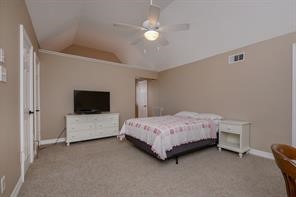 896 Davis Road League City, TX 77573 - Photo 40 of 46 a bedroom with a bed and a flat screen tv