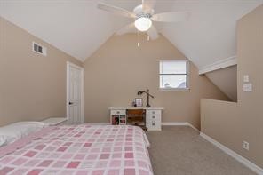 896 Davis Road League City, TX 77573 - Photo 42 of 46 a bedroom with a bed and a chandelier