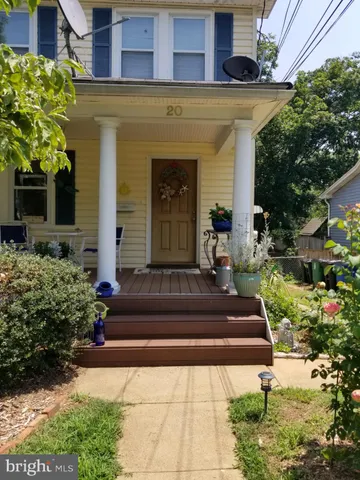 a front view of a house with potted plants