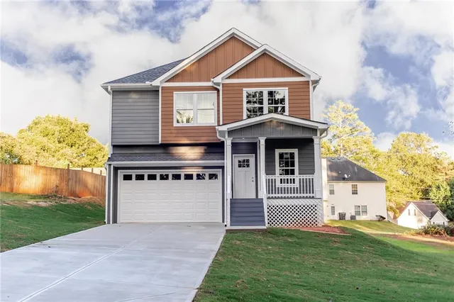 a front view of a house with a yard and garage