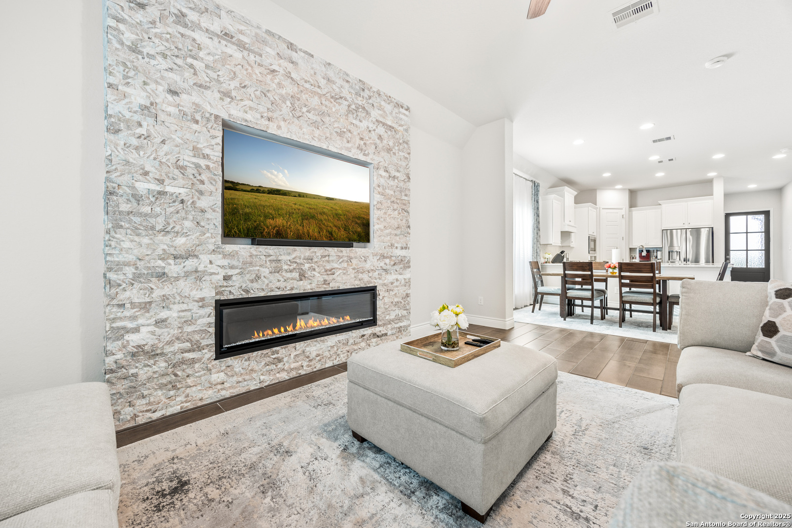 2108 Calate Ridge San Antonio, TX 78253 - Photo 11 of 25 a living room with furniture a flat screen tv and a fireplace