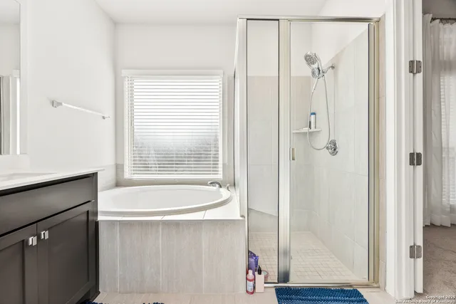 a bathroom with a bathtub and a shower