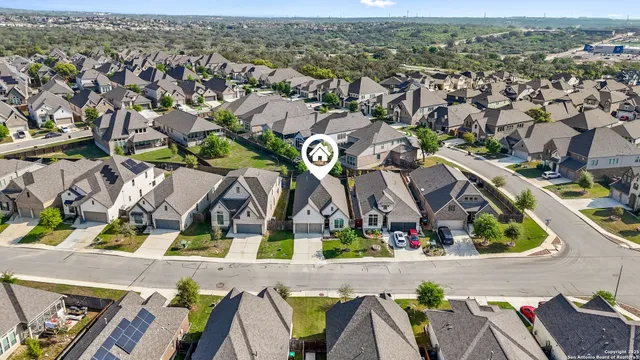 an aerial view of residential house with outdoor space and swimming pool