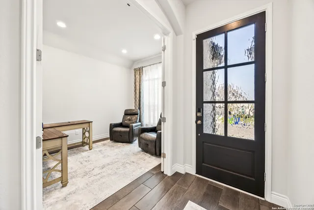 a room with a bed a couch and a window