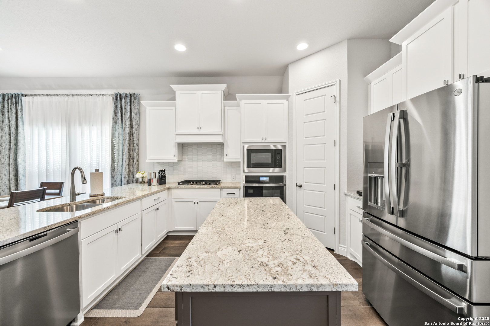 2108 Calate Ridge San Antonio, TX 78253 - Photo 7 of 25 a large kitchen with stainless steel appliances granite countertop a sink refrigerator and microwave