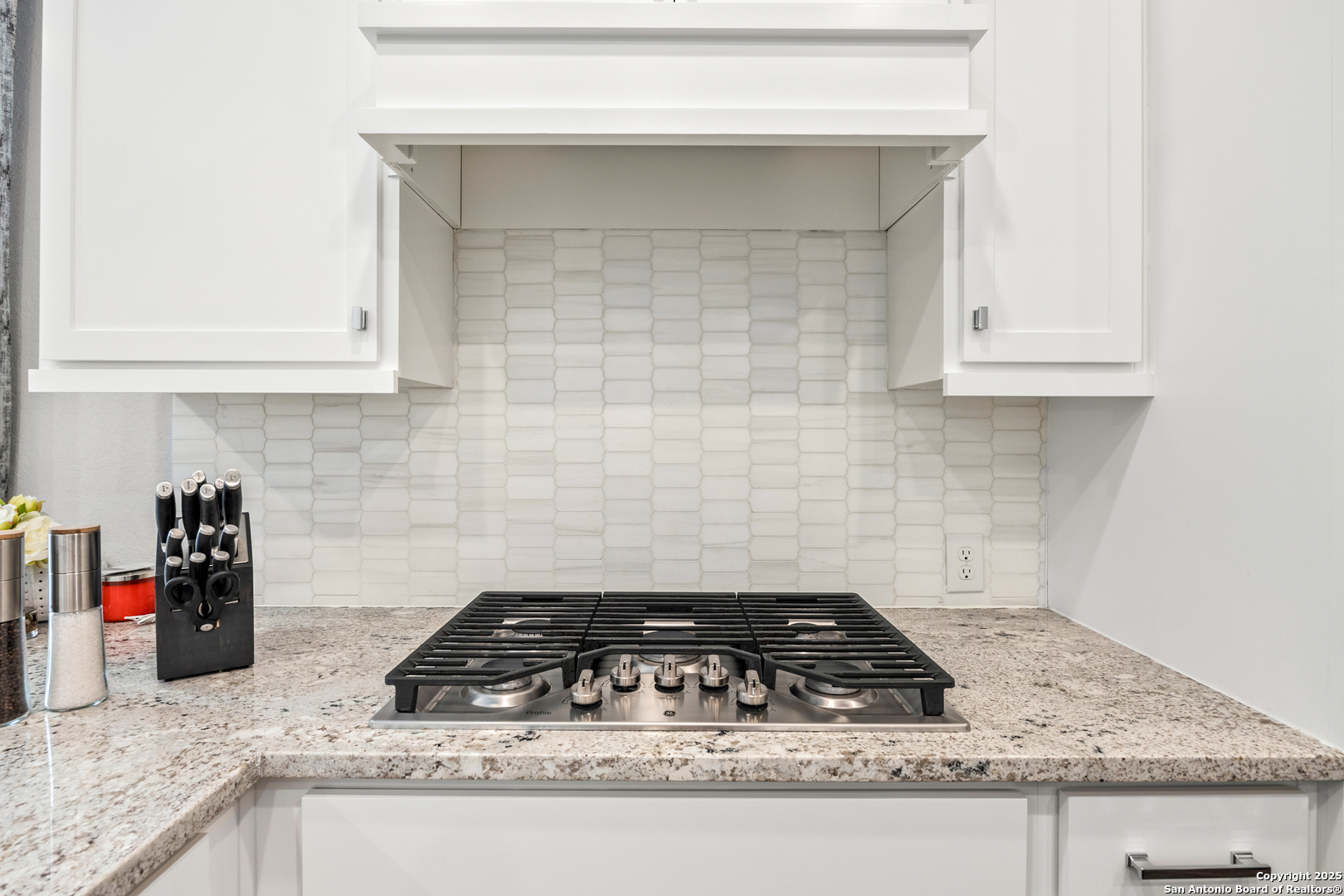 2108 Calate Ridge San Antonio, TX 78253 - Photo 8 of 25 a kitchen with granite countertop white cabinets and a stove
