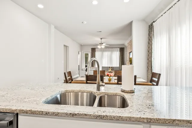 a kitchen with granite countertop a sink and a granite top