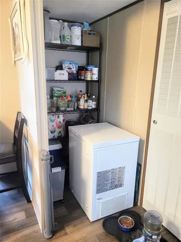 a bedroom with a bed and a flat tv screen on the dresser