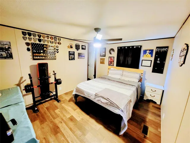 a bedroom with furniture and a wooden floor