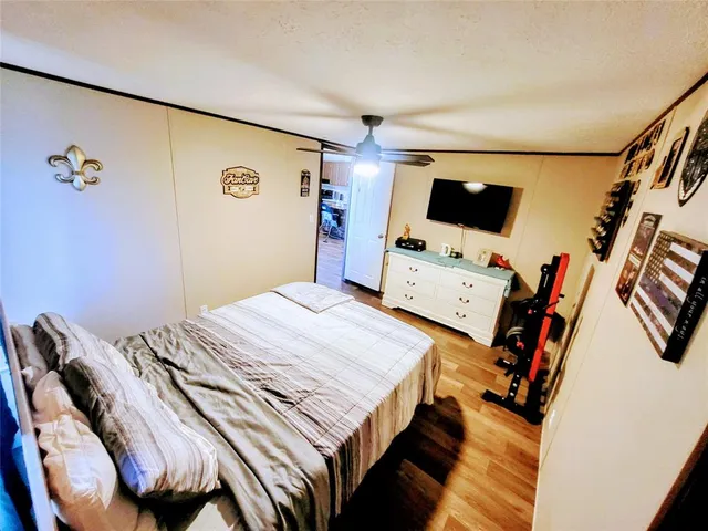 a bedroom with a bed and painting on the wall
