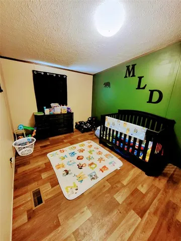 a bedroom with furniture and a flat tv screen