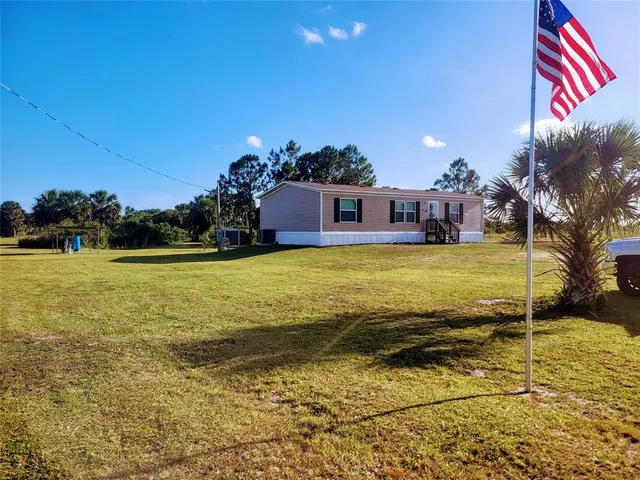 a view of a pool with an outdoor space and seating area