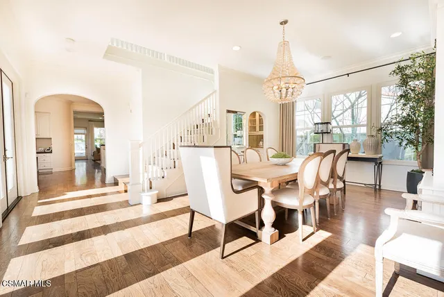 a view of a dining room with furniture wooden floor and a chandelier