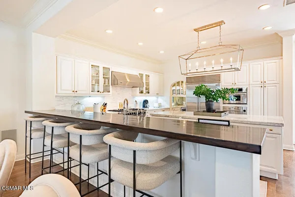 a kitchen with granite countertop a sink and stove