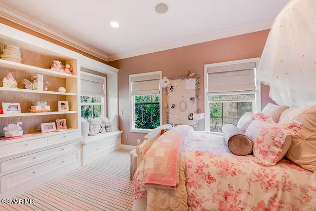 a bedroom with a bed and large window