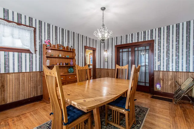 a view of a dining room with furniture and a chandelier