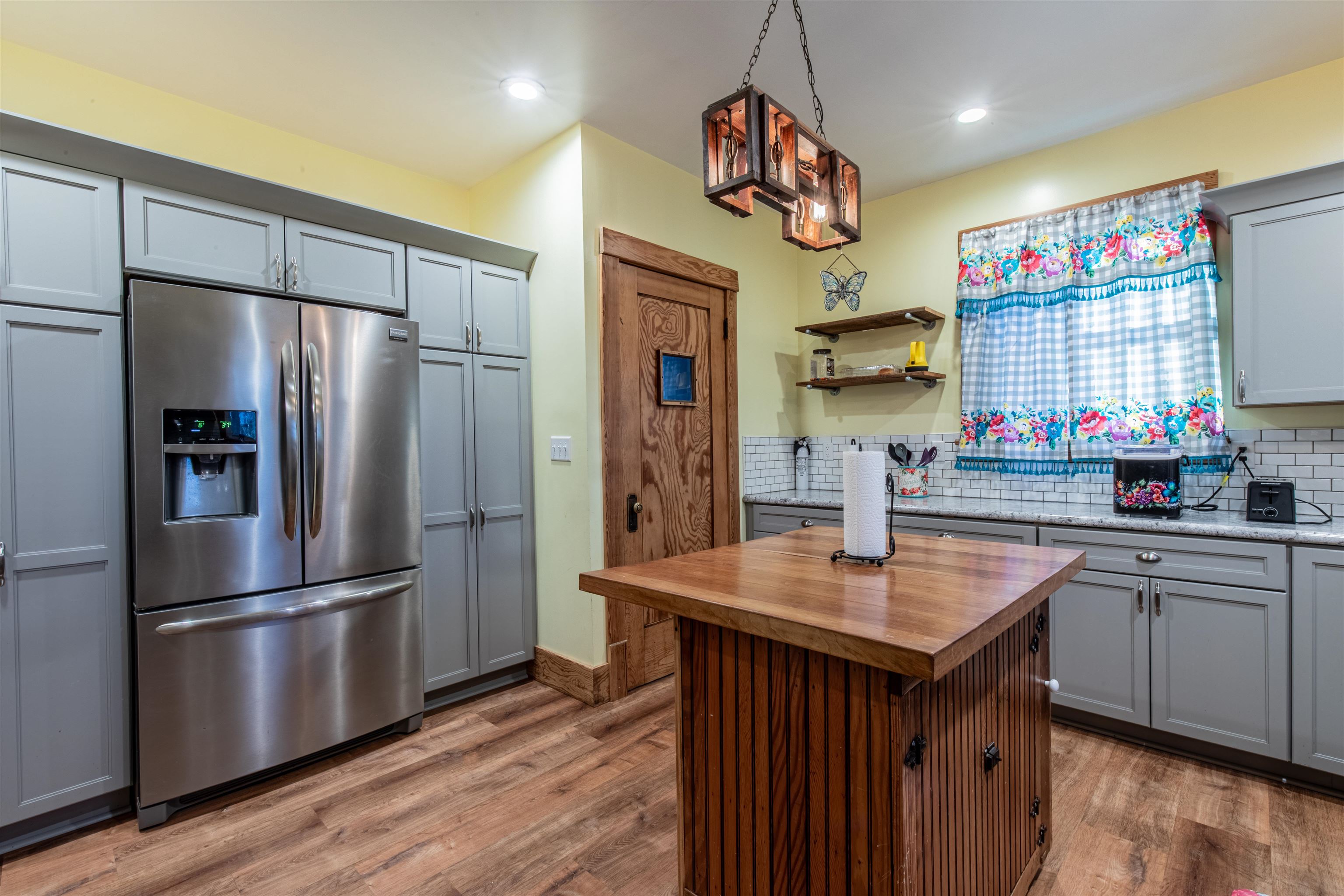 72 North Main Street La Moille, IL 61330 - Photo 14 of 31 a kitchen with stainless steel appliances granite countertop a refrigerator a sink dishwasher and a refrigerator with wooden floor
