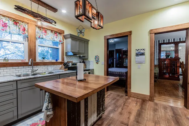 a kitchen with a sink a counter top space and stainless steel appliances