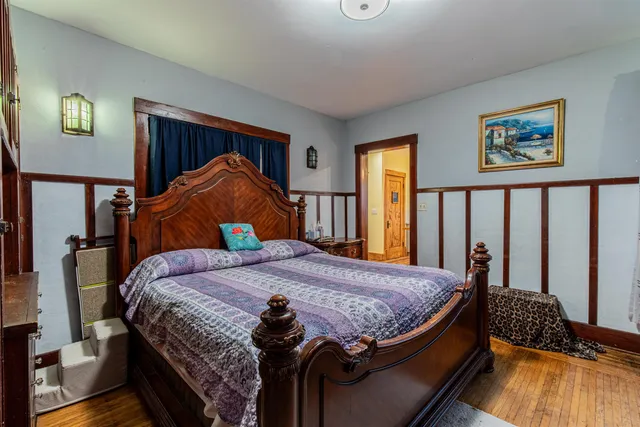 a bed sitting in a bedroom next to a window