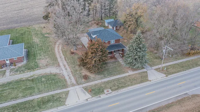 an aerial view of a house with a yard