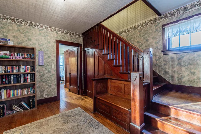 a view of hallway with wooden floor and stairs