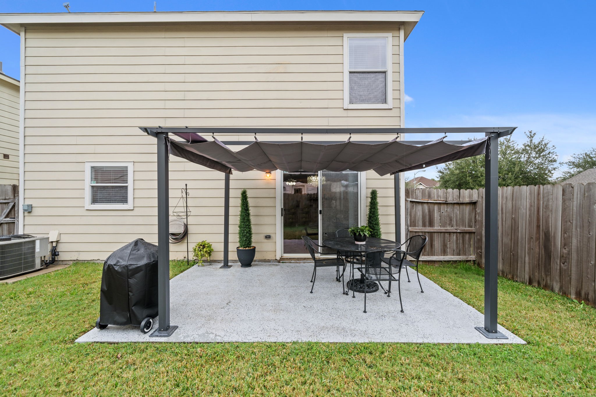 2903 Valiant Scene Court Houston, TX 77038 - Photo 15 of 19 a view of a patio with a table and chairs under an umbrella