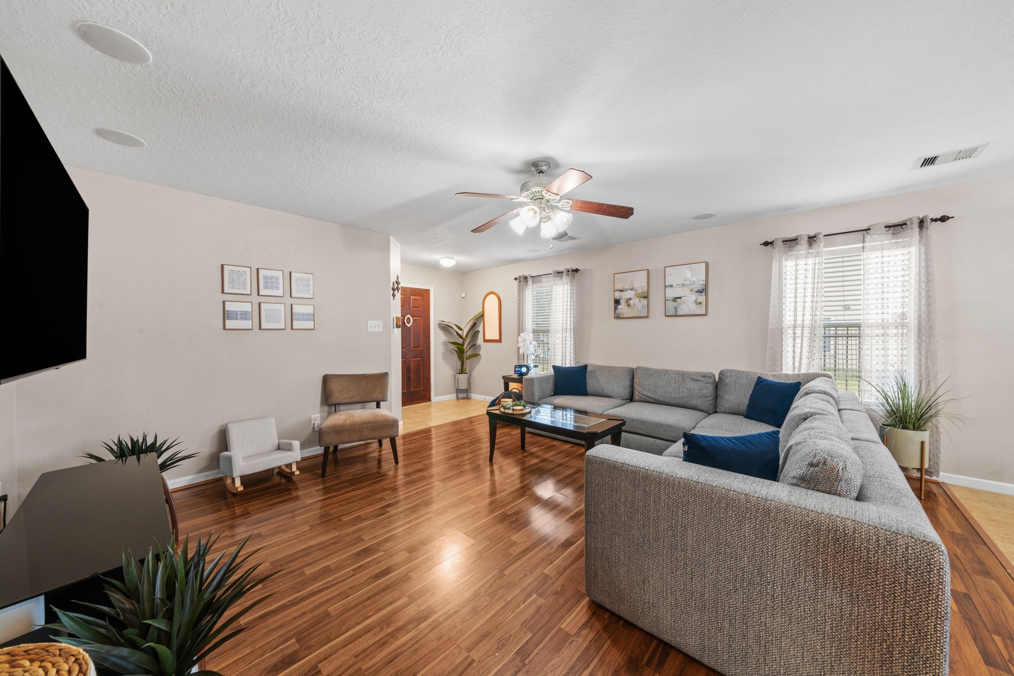 2903 Valiant Scene Court Houston, TX 77038 - Photo 2 of 19 a living room with furniture kitchen view and a flat screen tv