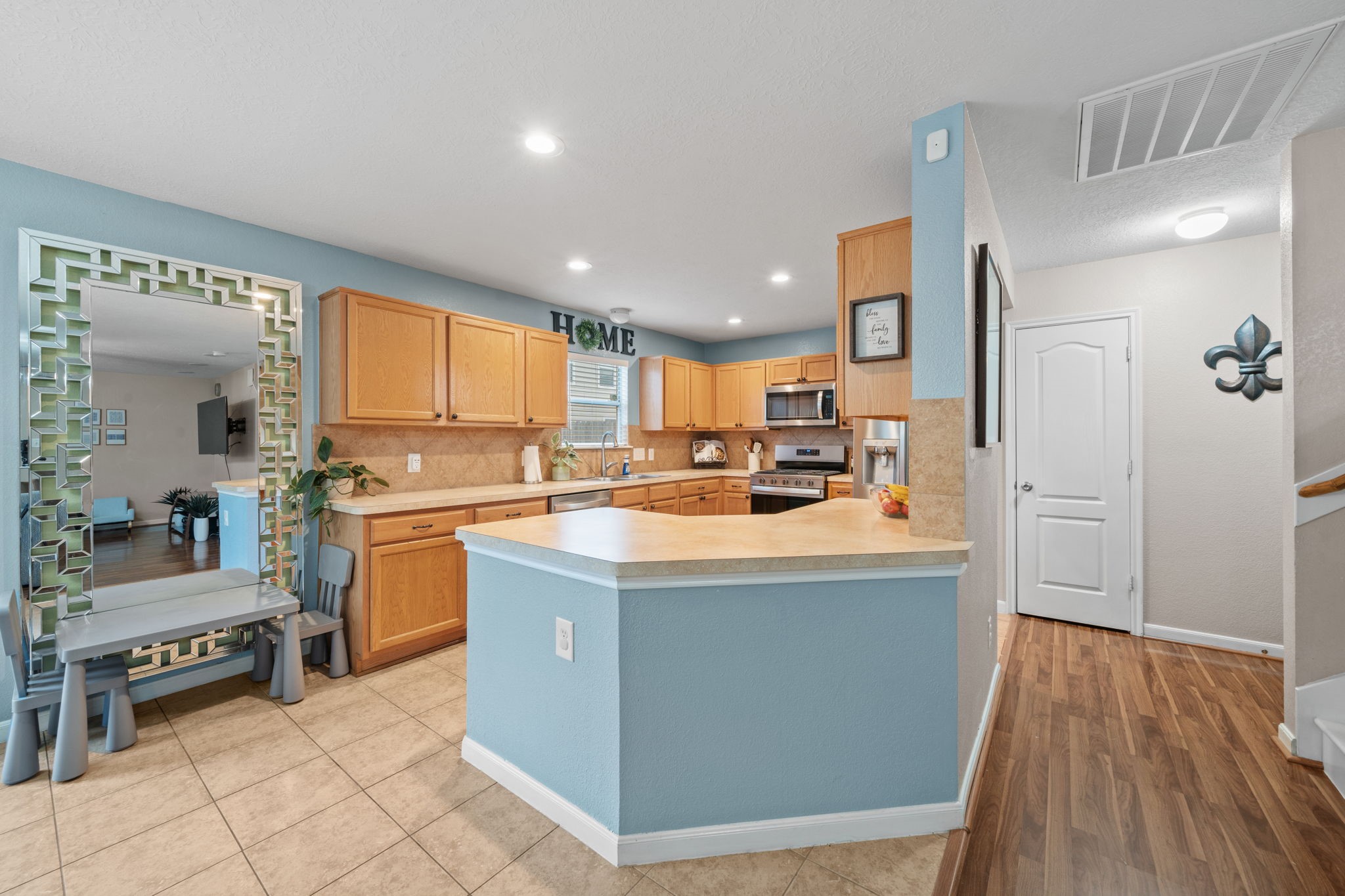 2903 Valiant Scene Court Houston, TX 77038 - Photo 4 of 19 a kitchen with stainless steel appliances kitchen island granite countertop a stove and a refrigerator