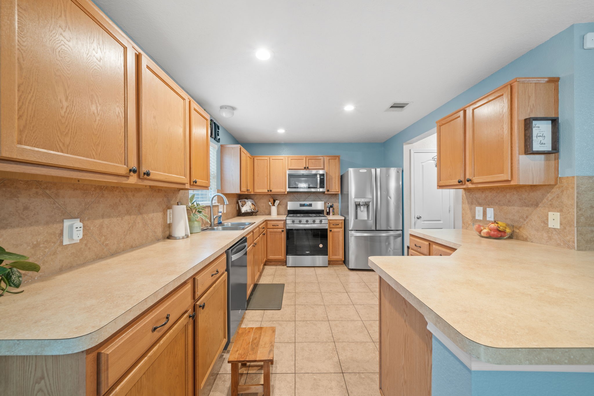 2903 Valiant Scene Court Houston, TX 77038 - Photo 5 of 19 a kitchen with stainless steel appliances kitchen island granite countertop a sink and cabinets