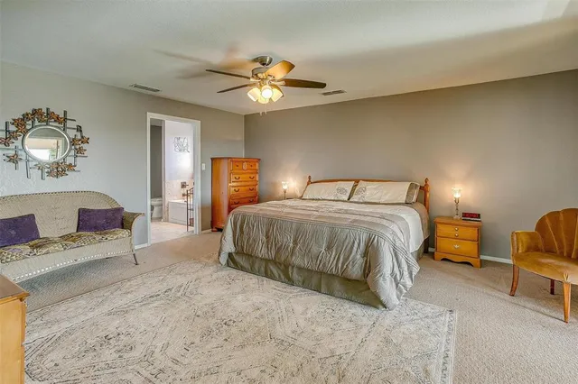 a spacious bedroom with a bed and a table