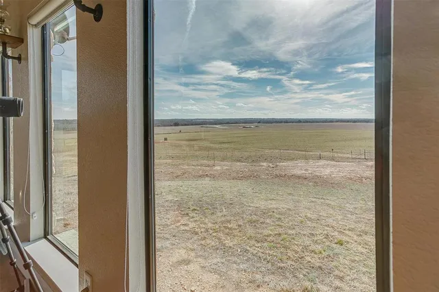 a view of house with garage and yard