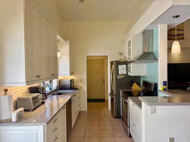a kitchen with a sink stove and refrigerator