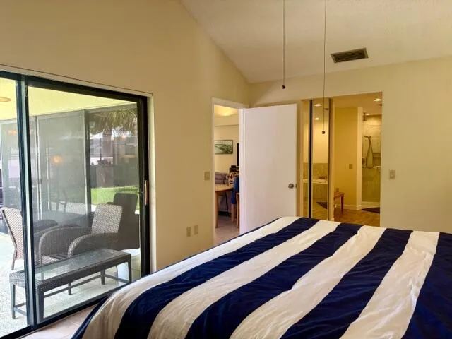a bedroom with a bed and a glass door