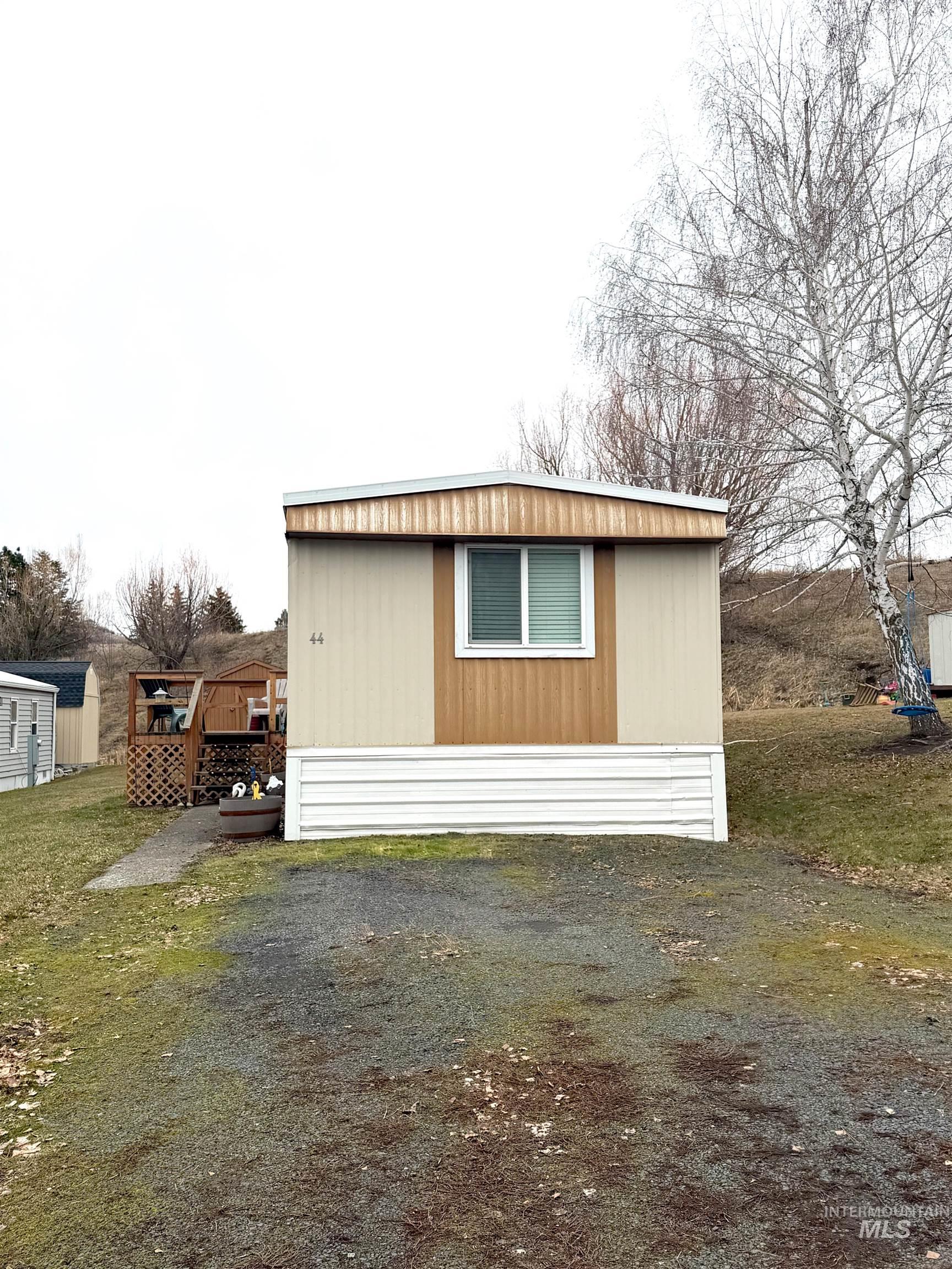 4325 Lenville Road, Unit 44 Moscow, ID 83843 - Photo 2 of 20 View of property exterior featuring a deck and an outdoor structure