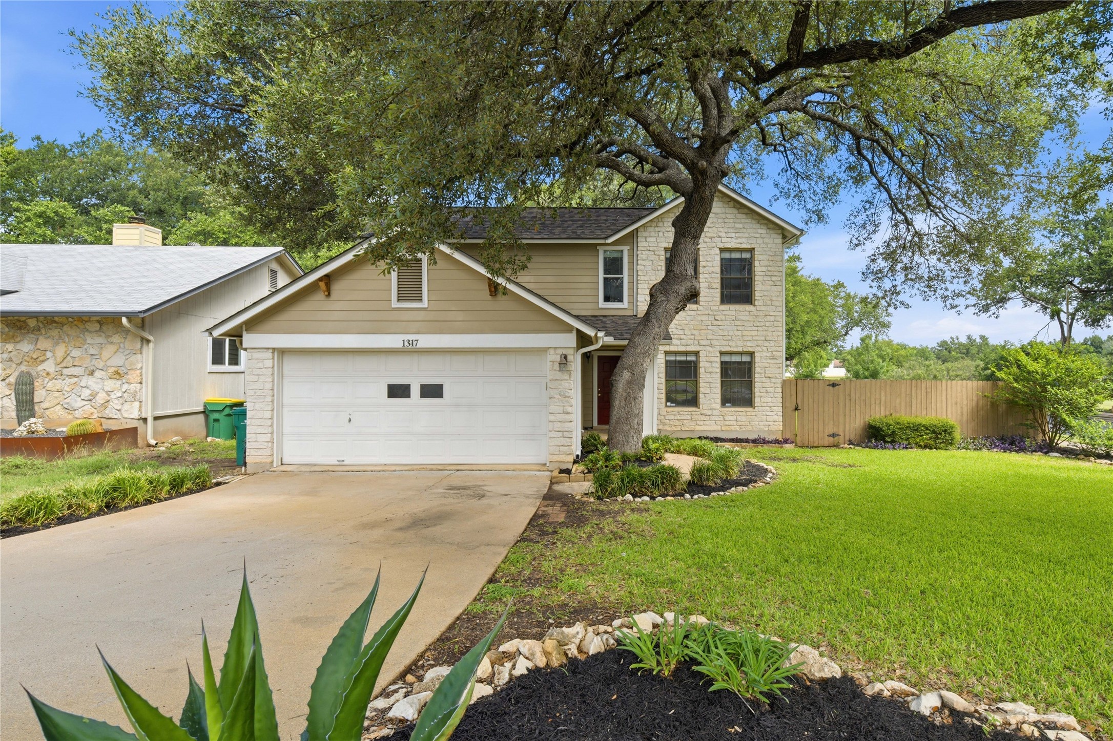 1317 Mimosa Pass Cedar Park, TX 78613 - Photo 1 of 20 a front view of a house with garden