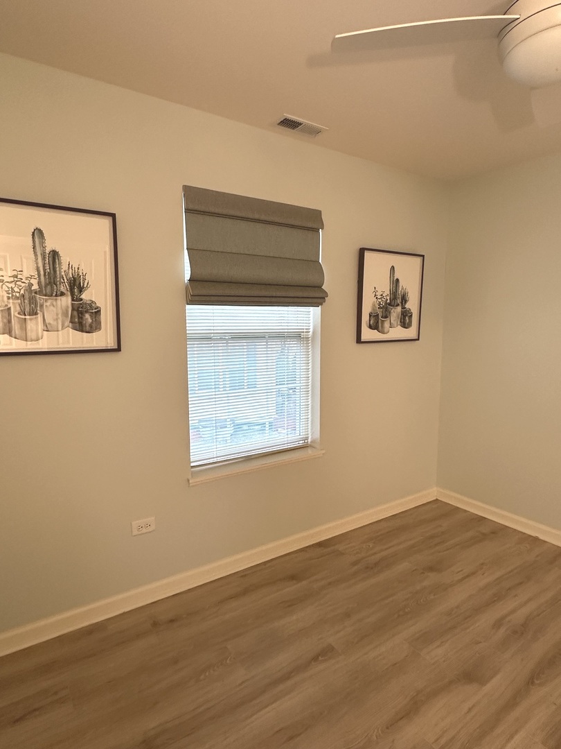 5102 Monroe Street Matteson, IL 60443 - Photo 39 of 54 a view of an empty room with wooden floor and a window
