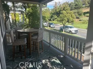 a view of a balcony with chairs and a table