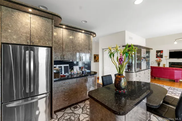 a living room with kitchen view and a wooden floor