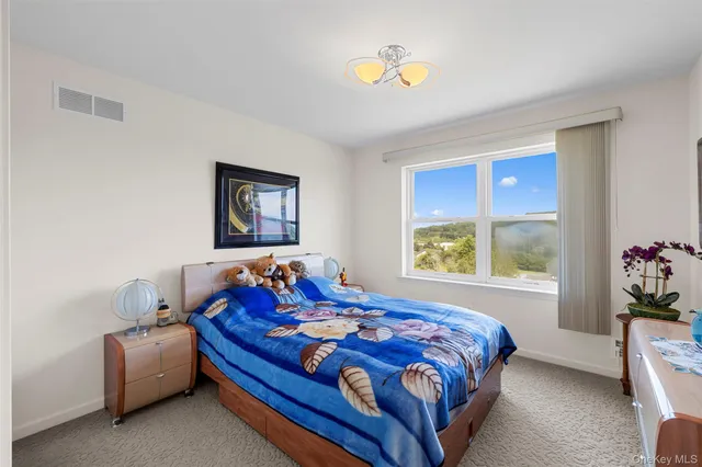 a bed sitting in a bedroom next to a window