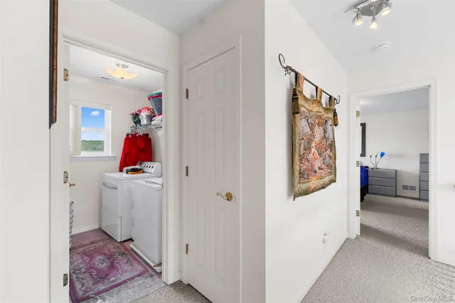 a view of a hallway with workspace and entryway