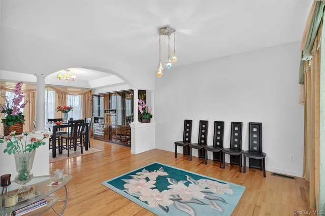 an outdoor space with lots of furniture and wooden floor