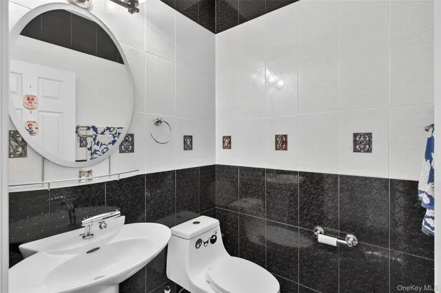 a bathroom with a sink a toilet and mirror