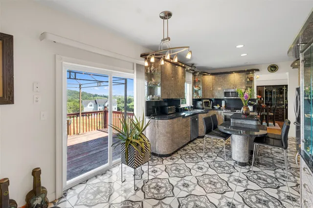 a kitchen with a chandelier dining table and chairs