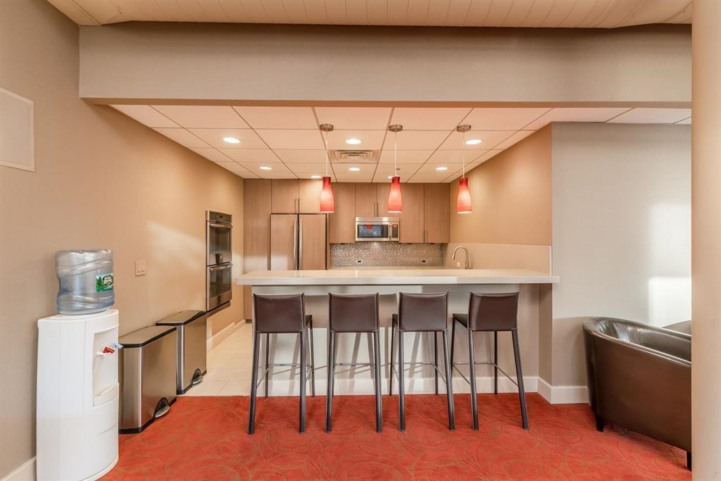 250 Gorge Road Cliffside Park, NJ 07010 - Photo 39 of 46 a kitchen with a table chairs refrigerator and microwave
