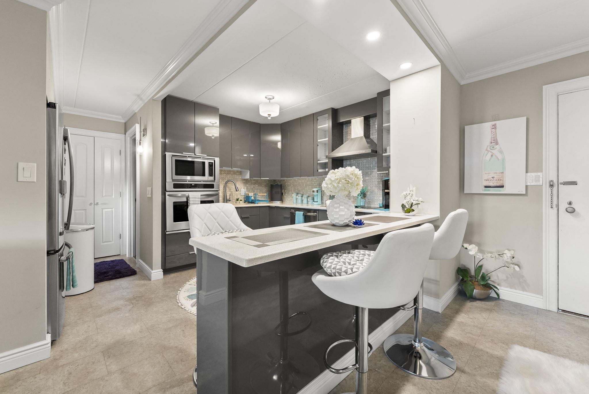 250 Gorge Road Cliffside Park, NJ 07010 - Photo 5 of 46 a kitchen with a table chairs refrigerator and cabinets