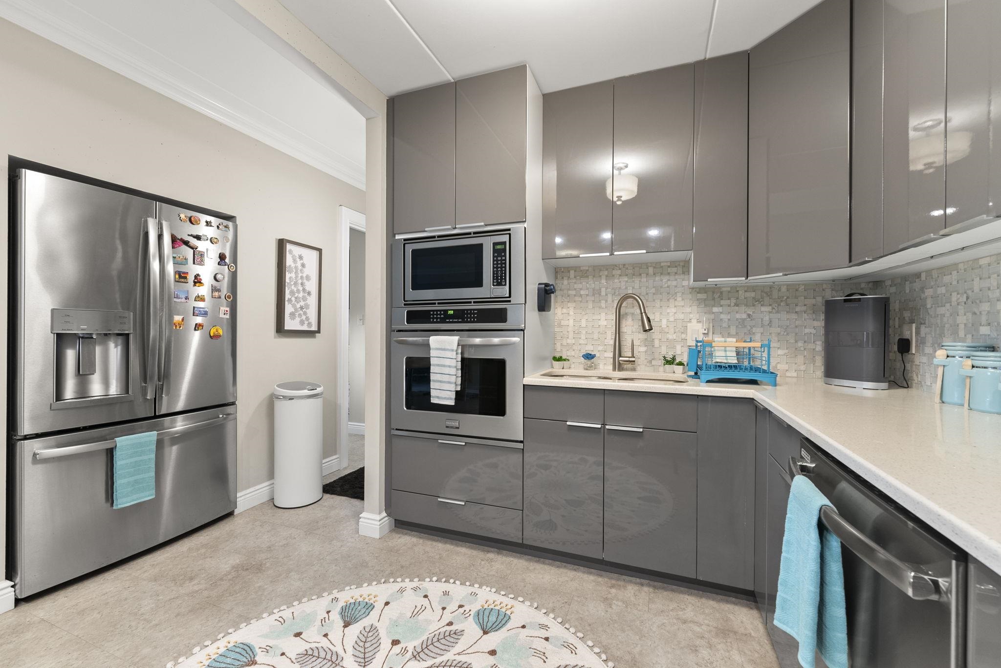 250 Gorge Road Cliffside Park, NJ 07010 - Photo 8 of 46 a kitchen with stainless steel appliances a refrigerator sink and microwave