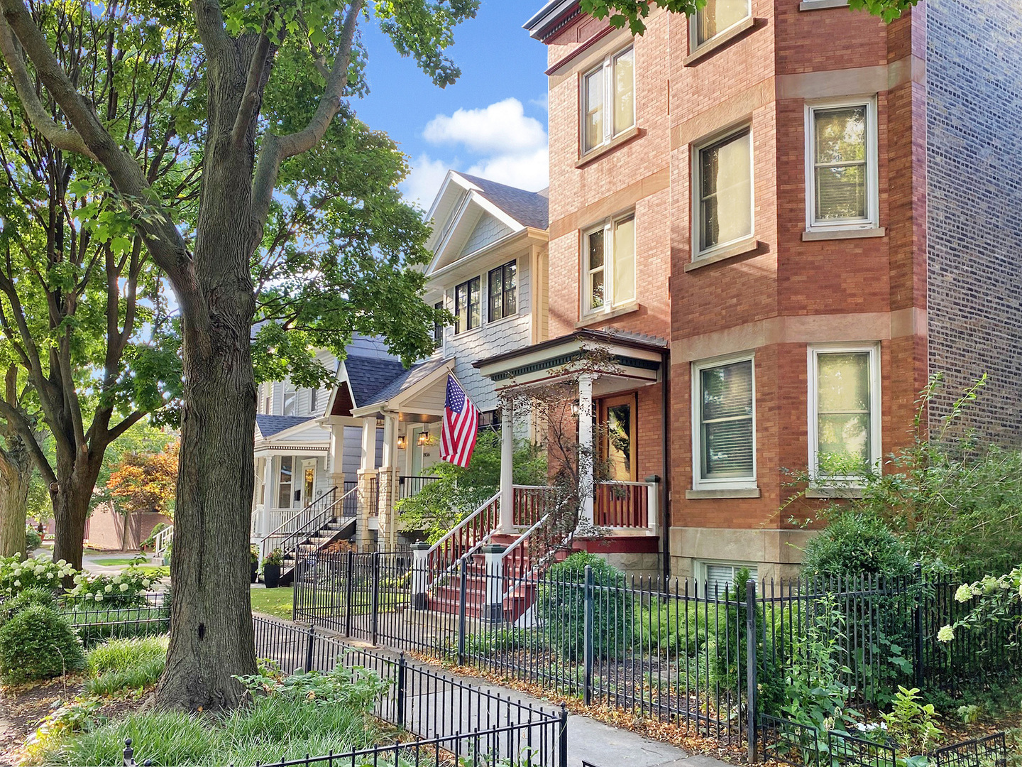 front view of a brick house with a small yard