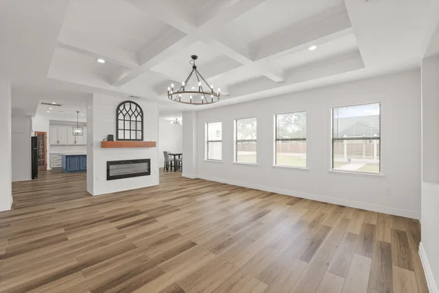 a view of livingroom with stainless steel appliances wooden floor and fireplace