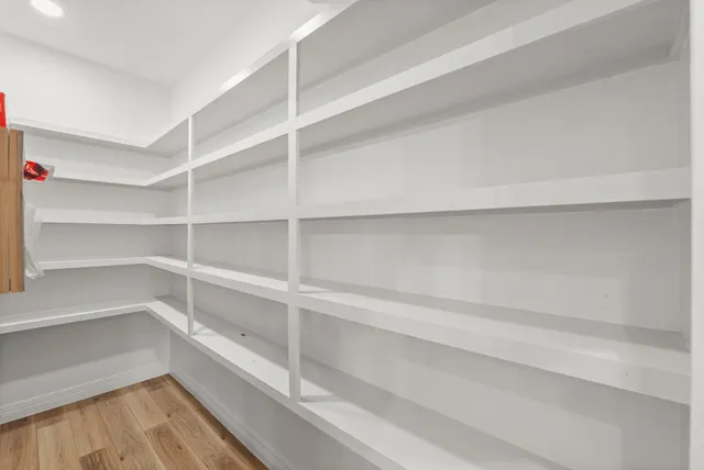 a view of walk in closet with empty racks